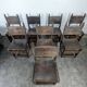 Set of 8 Gothic-style chairs in oak and studded leather.