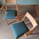 Scandinavian armchairs with green tapered legs.