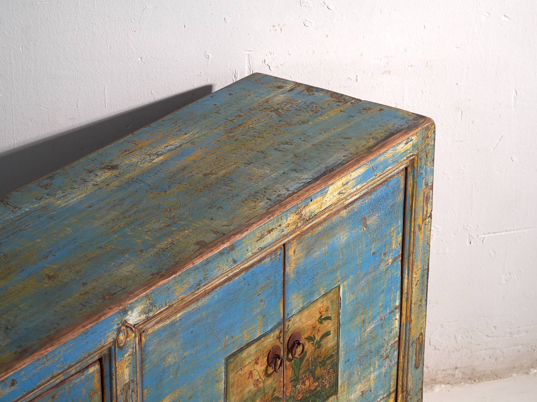 Old wooden entrance buffet in blue and yellow tones (circa 1920).