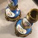 Pair of xixth candle holders, in bronze and enamelled porcelain