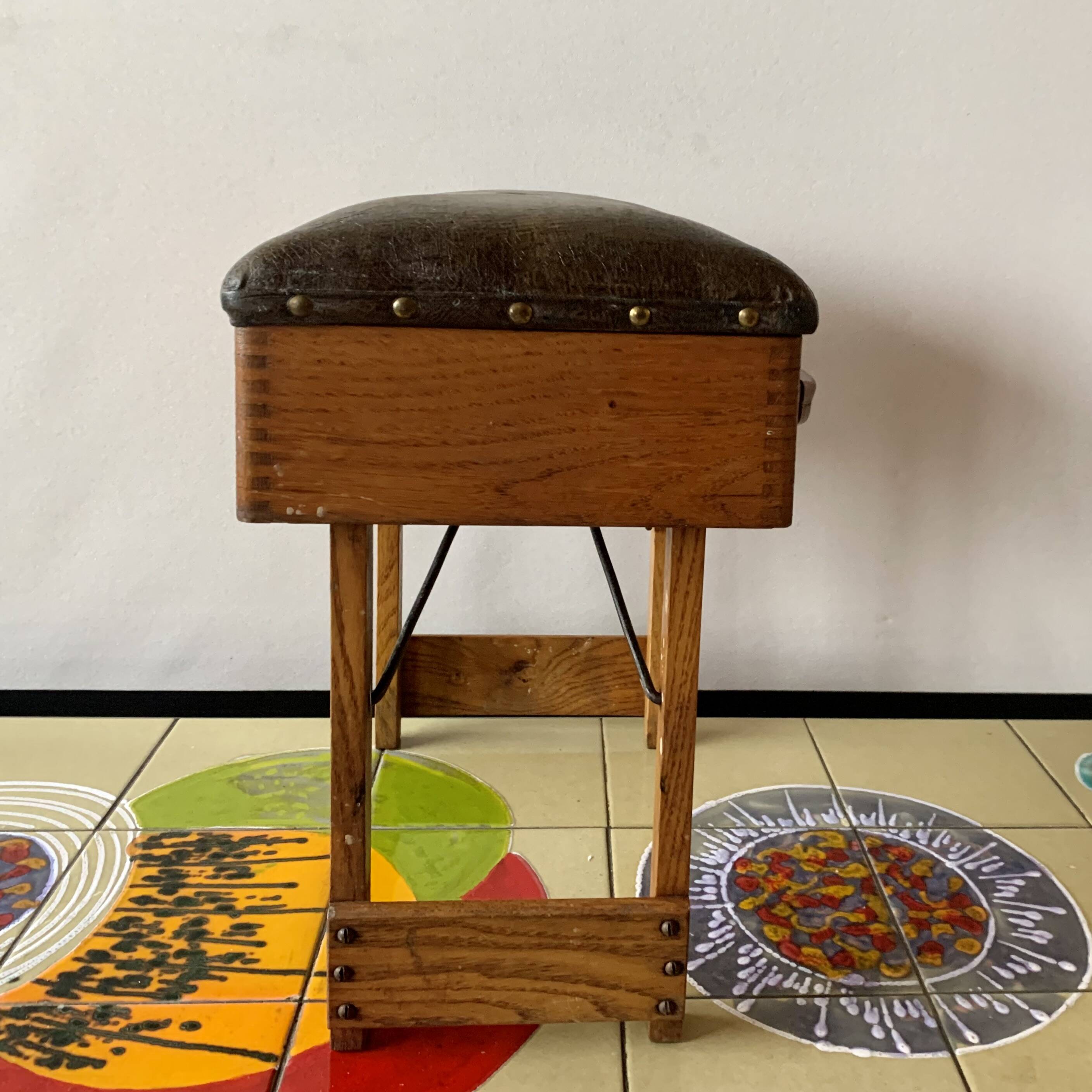 Old foldable fisherman's stool in wood and leather