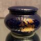 Porcelain candy box with golden floral decoration on a midnight blue background