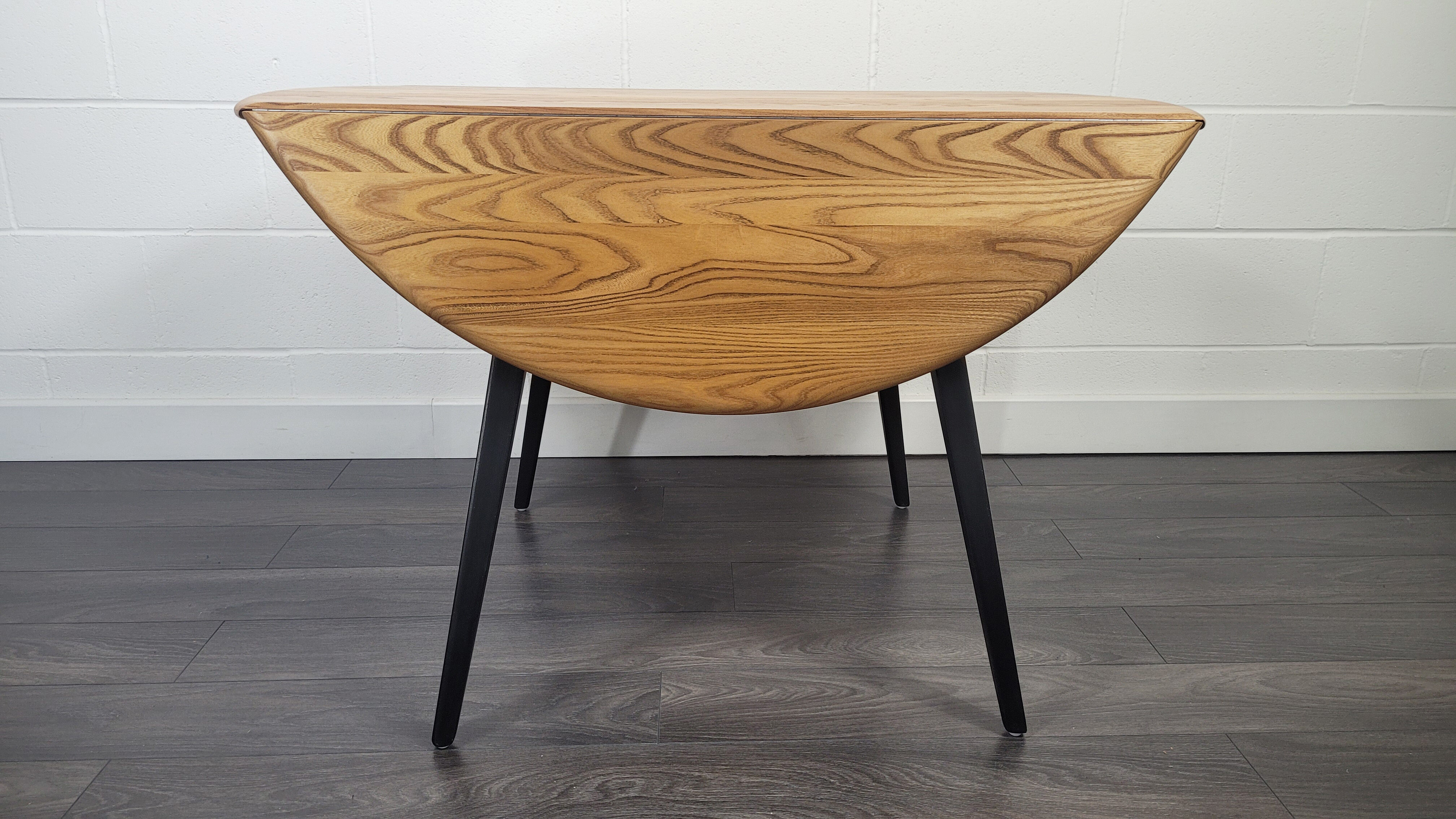 Ercol round drop leaf dining table - black leg, 1960