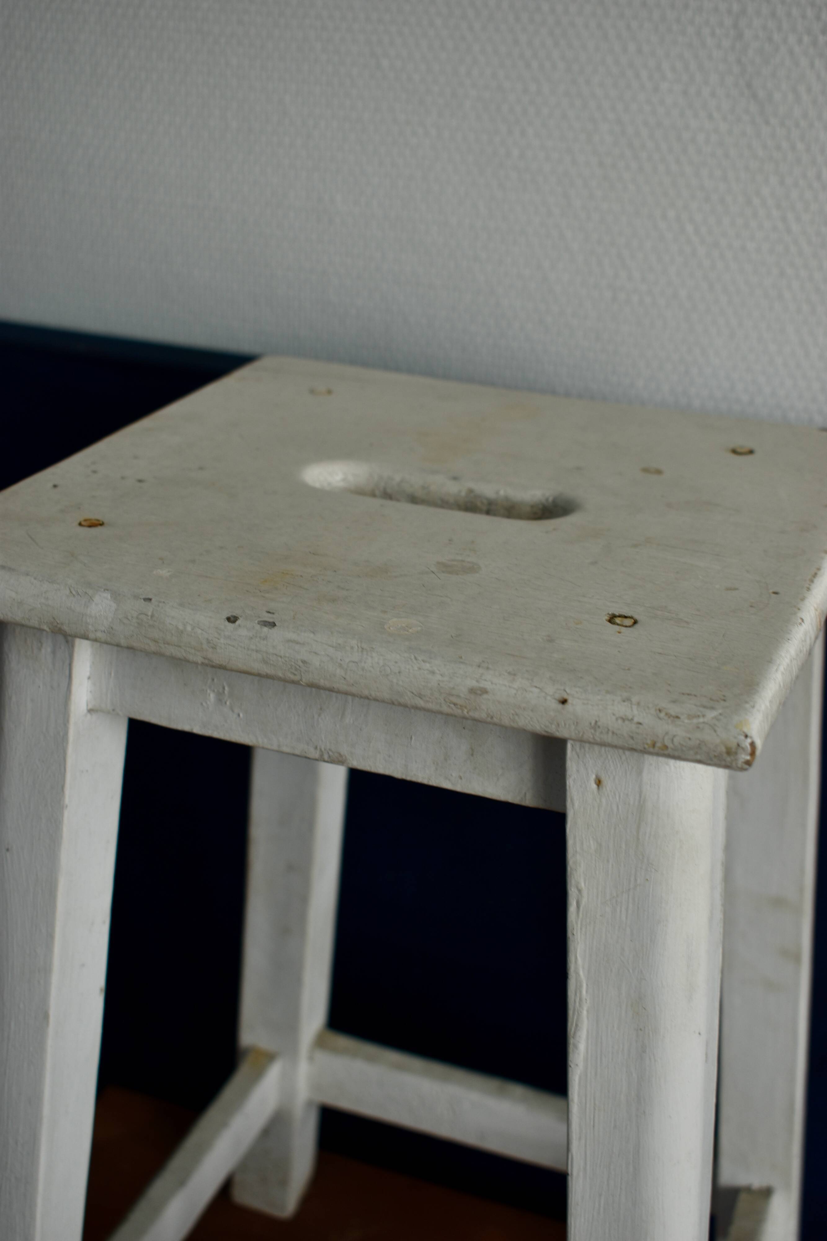 Old white wooden handle stool