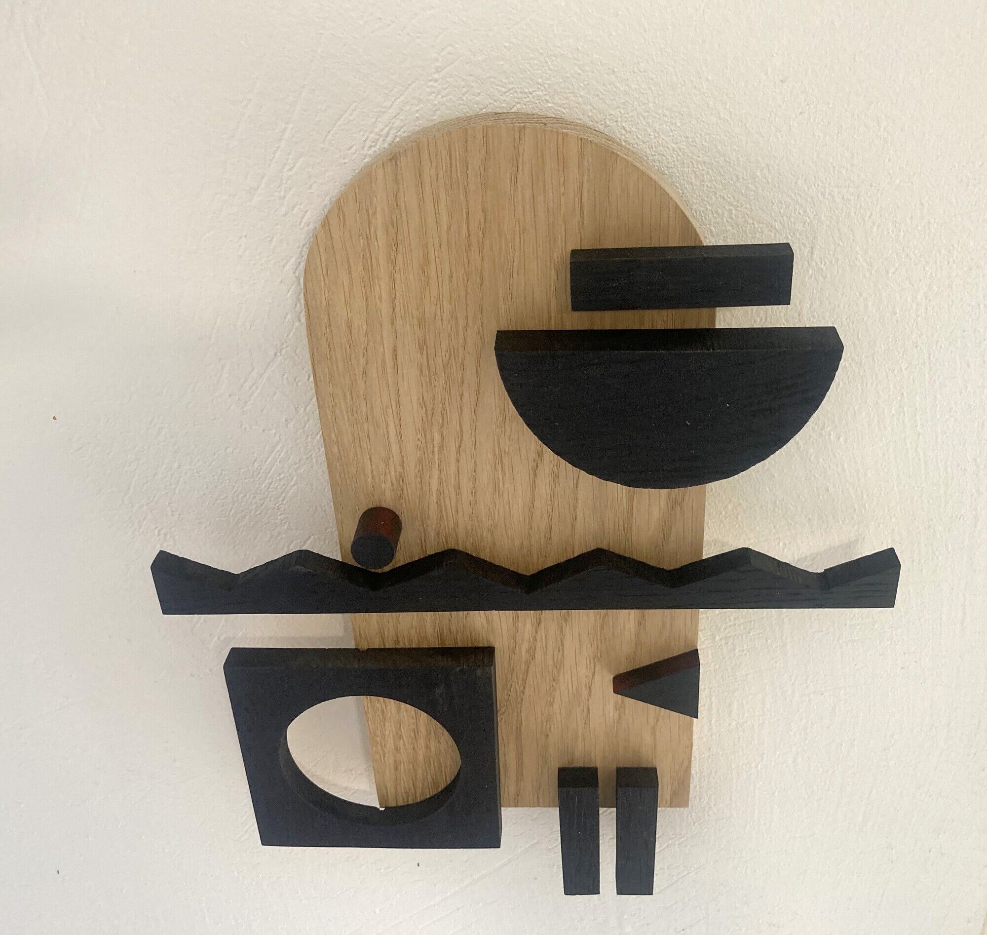 Geometric wooden painting - relief collage of natural and black wood