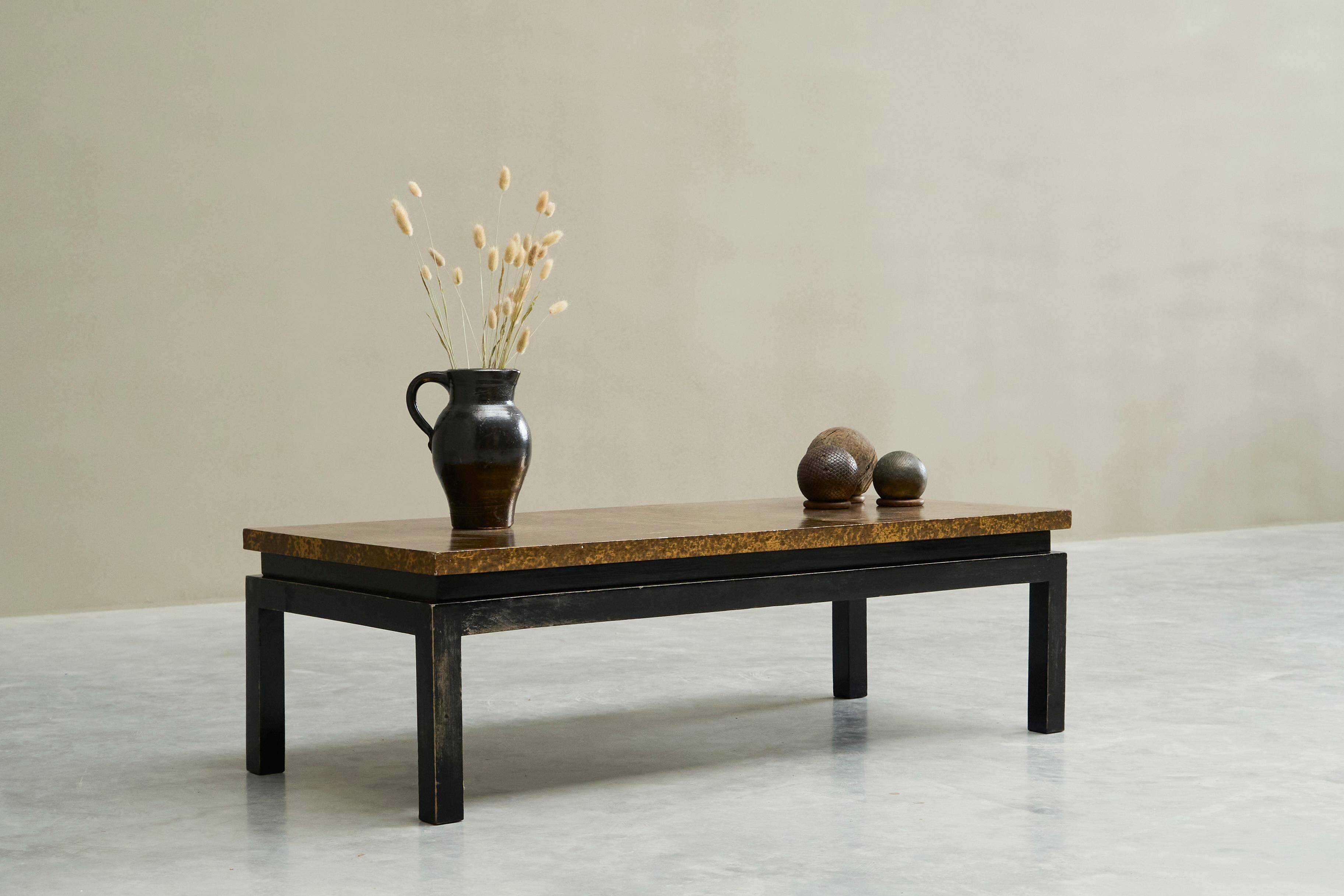 Modernist coffee table with a patinated gold top, 120x52.5x36 cm, mid-20th century.