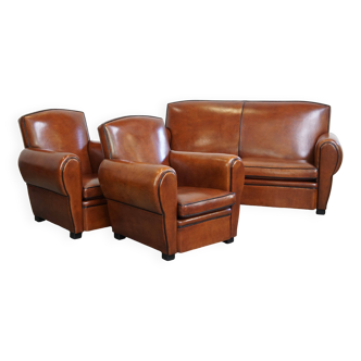 Very beautiful complete set consisting of a sheepskin leather sofa and two armchairs in cognac color