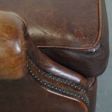 Sheep leather armchair on wheels