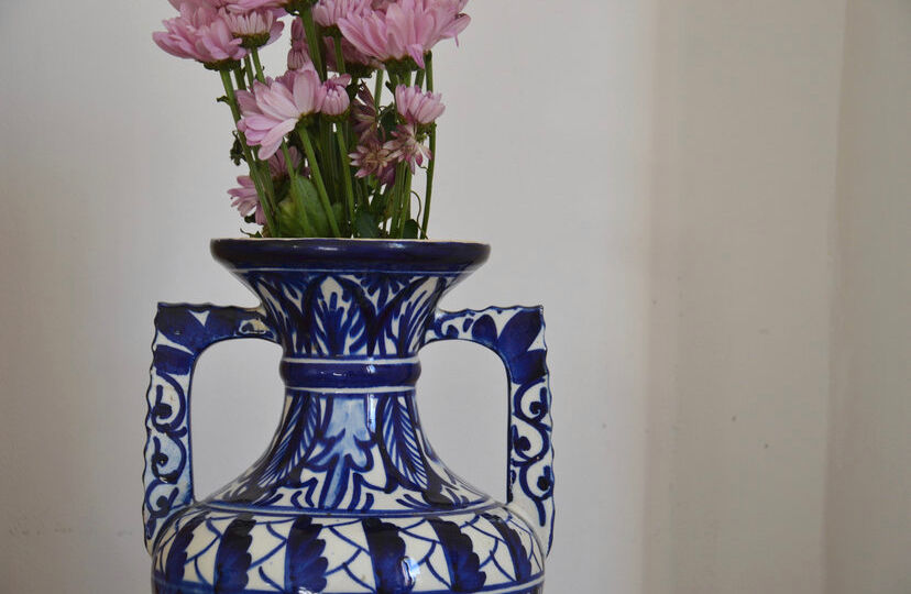 White hand-painted ceramic vase with blue patterns