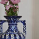 White hand-painted ceramic vase with blue patterns