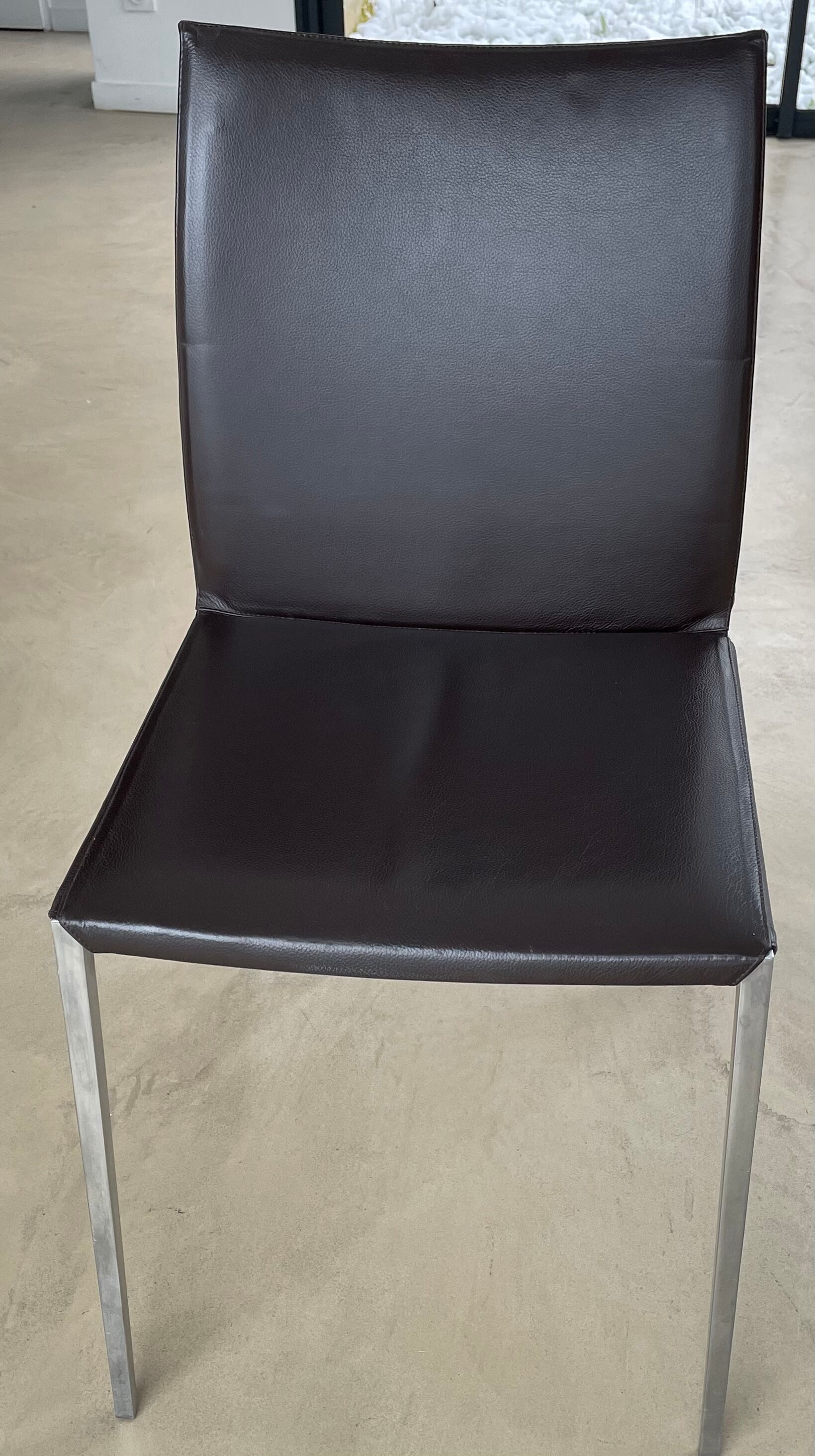 Brown leather chairs and Zanotta metal legs