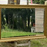 Large beveled mirror in wood and gilded stucco