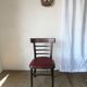 Set of 19 vintage wooden bistro chairs with red faux leather.