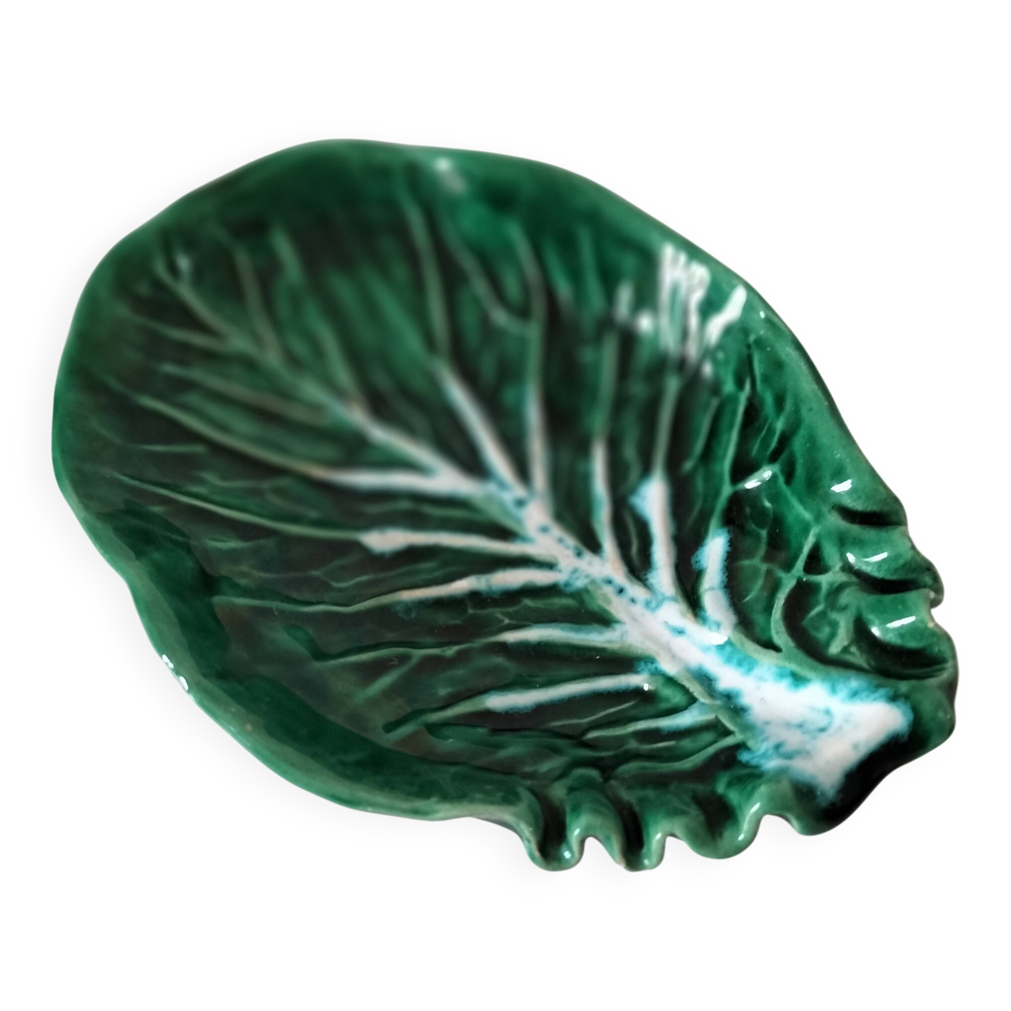 Vintage green slipware bowl in the shape of a cabbage leaf.
