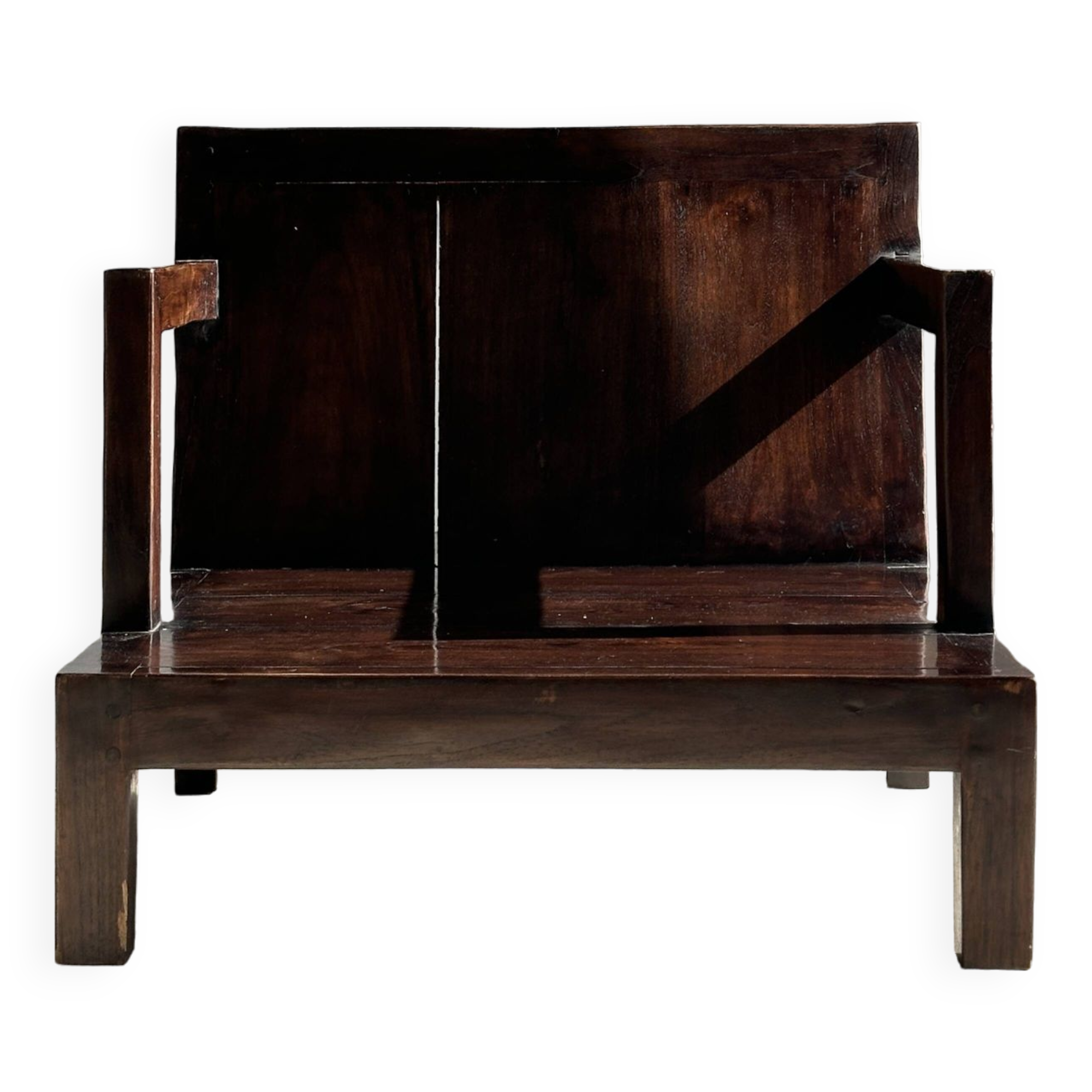 Small low armchair in varnished brown wood