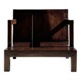 Small low armchair in varnished brown wood