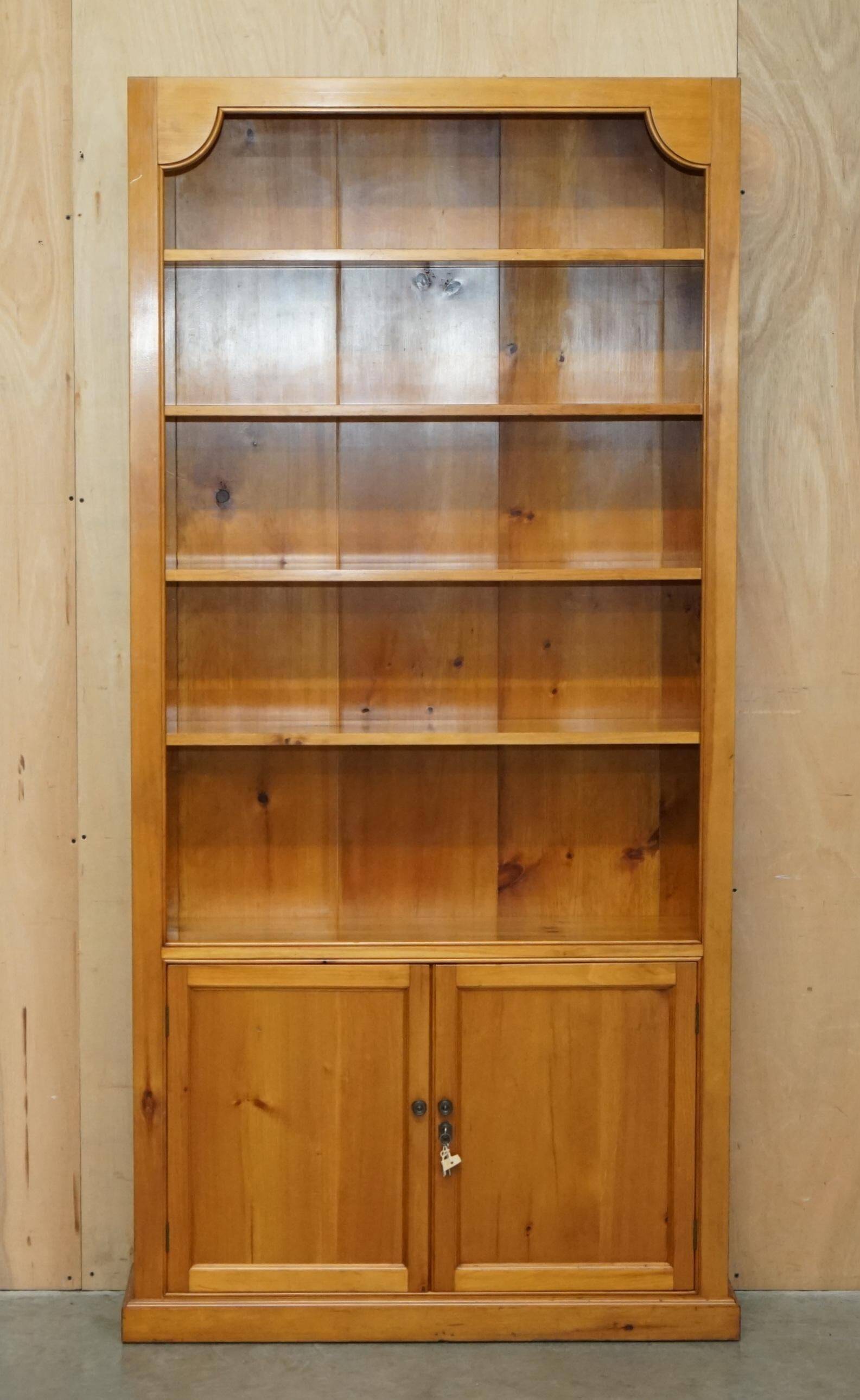 Pair of vintage cherry wood bookcases with lockable doors.