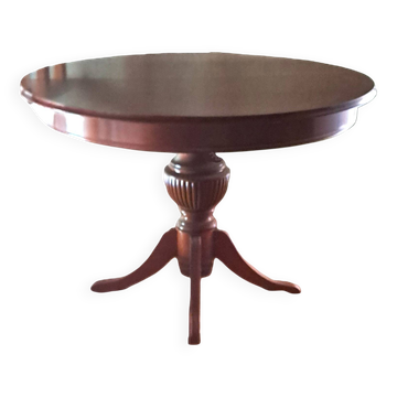 Round solid walnut table with central leg from the 1950s with extensions.