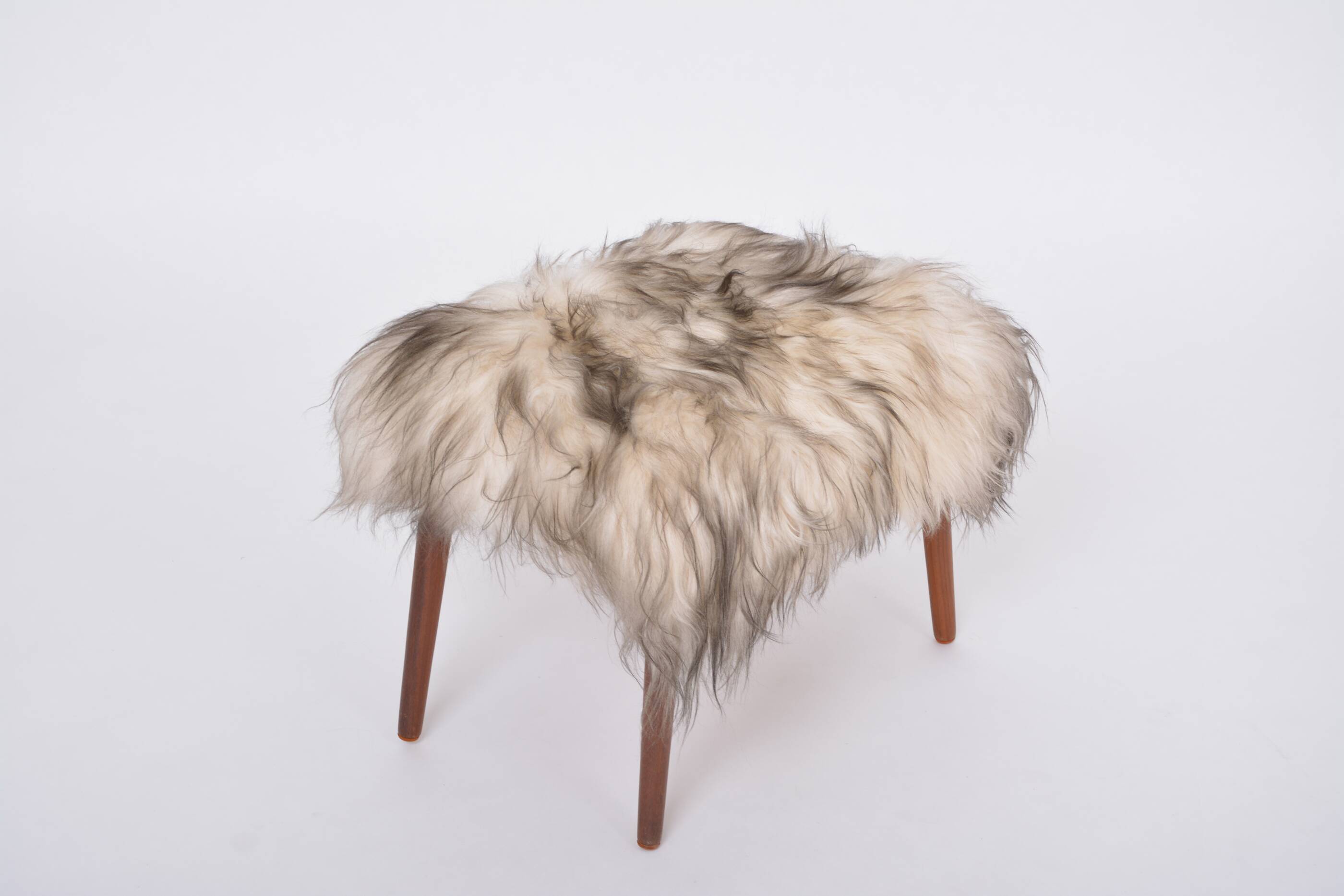 Danish Mid-century Modern stool reupholstered in white and black sheep skin