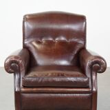 Comfortable and correct dark antique sheepskin English armchair in very good condition