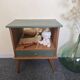 Renovated vintage bedside table in wood, with tapered legs – Matt green & gold background