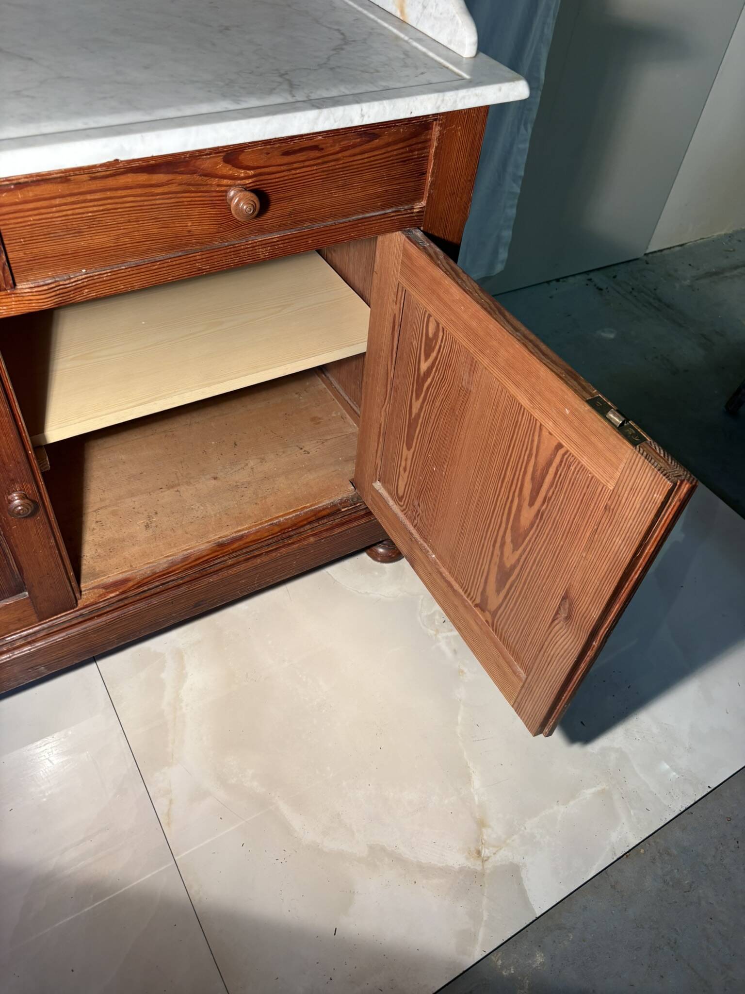 Antique wood and marble kitchen sideboard with carved backsplash
