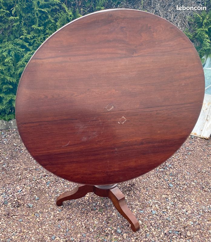 Old and large round winegrower's table made of wood.