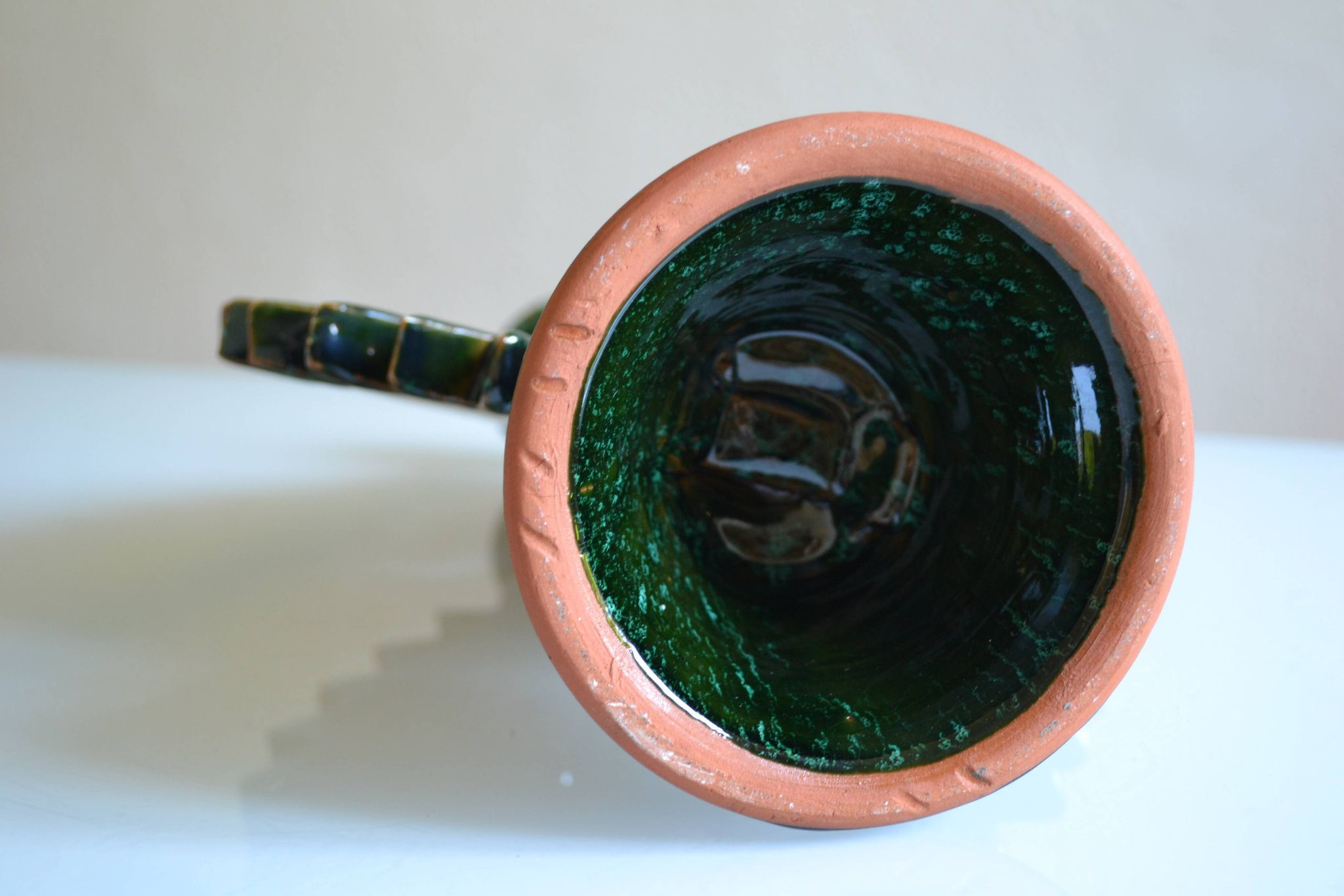 Green ceramic sun candlestick from Tamegroute, Morocco.