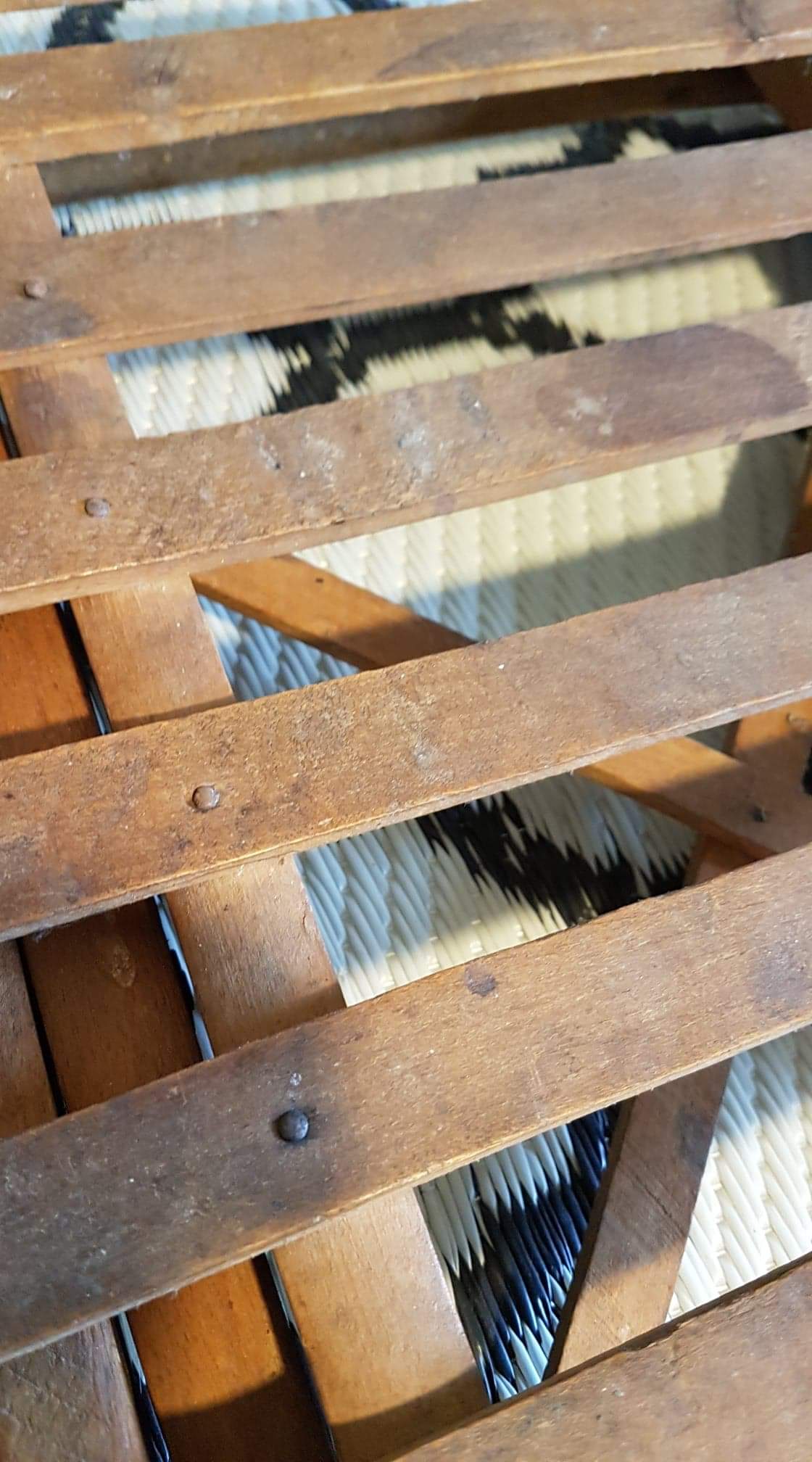 Old foldable stool in tinted wood