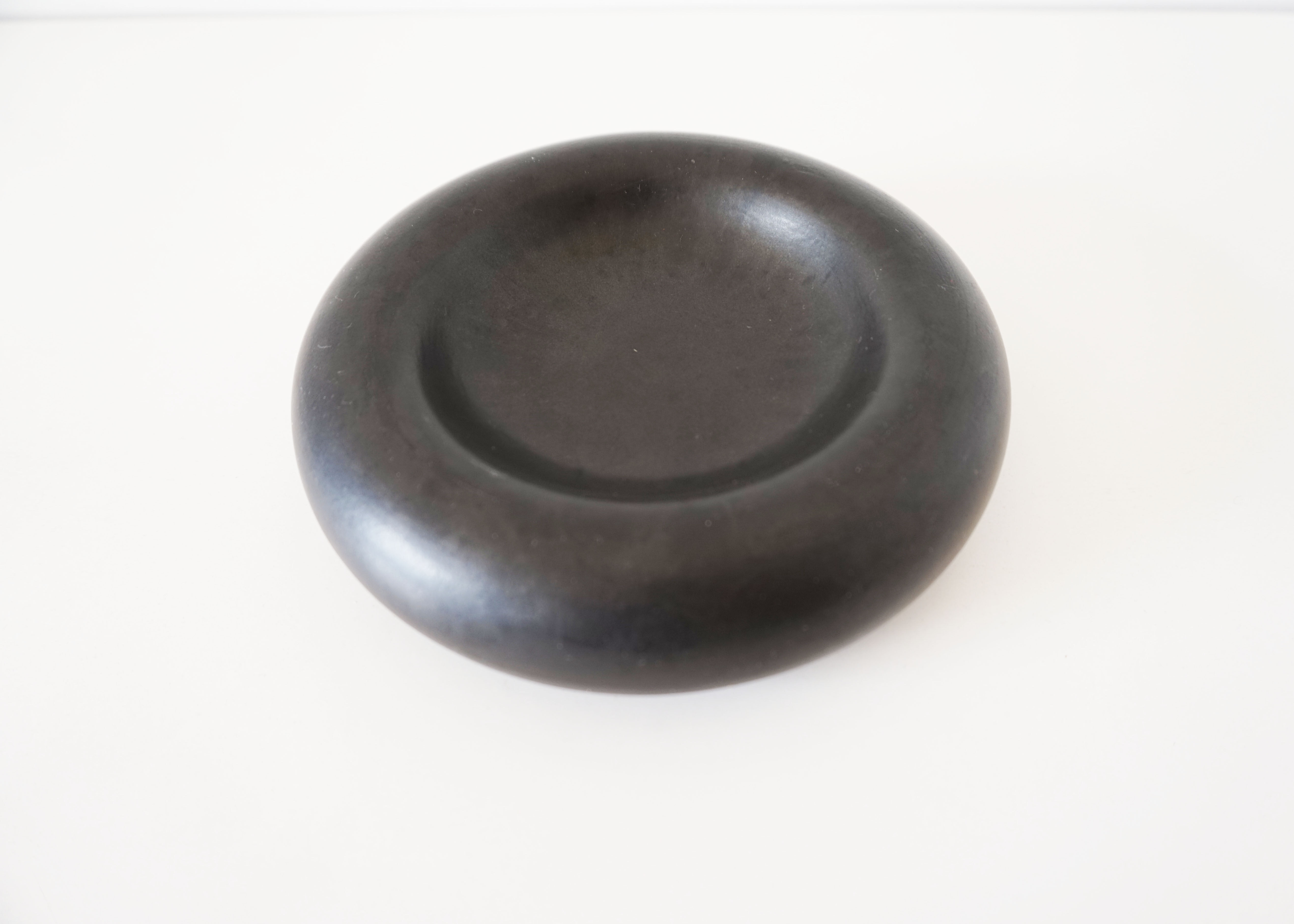 Empty round pocket in black ceramic