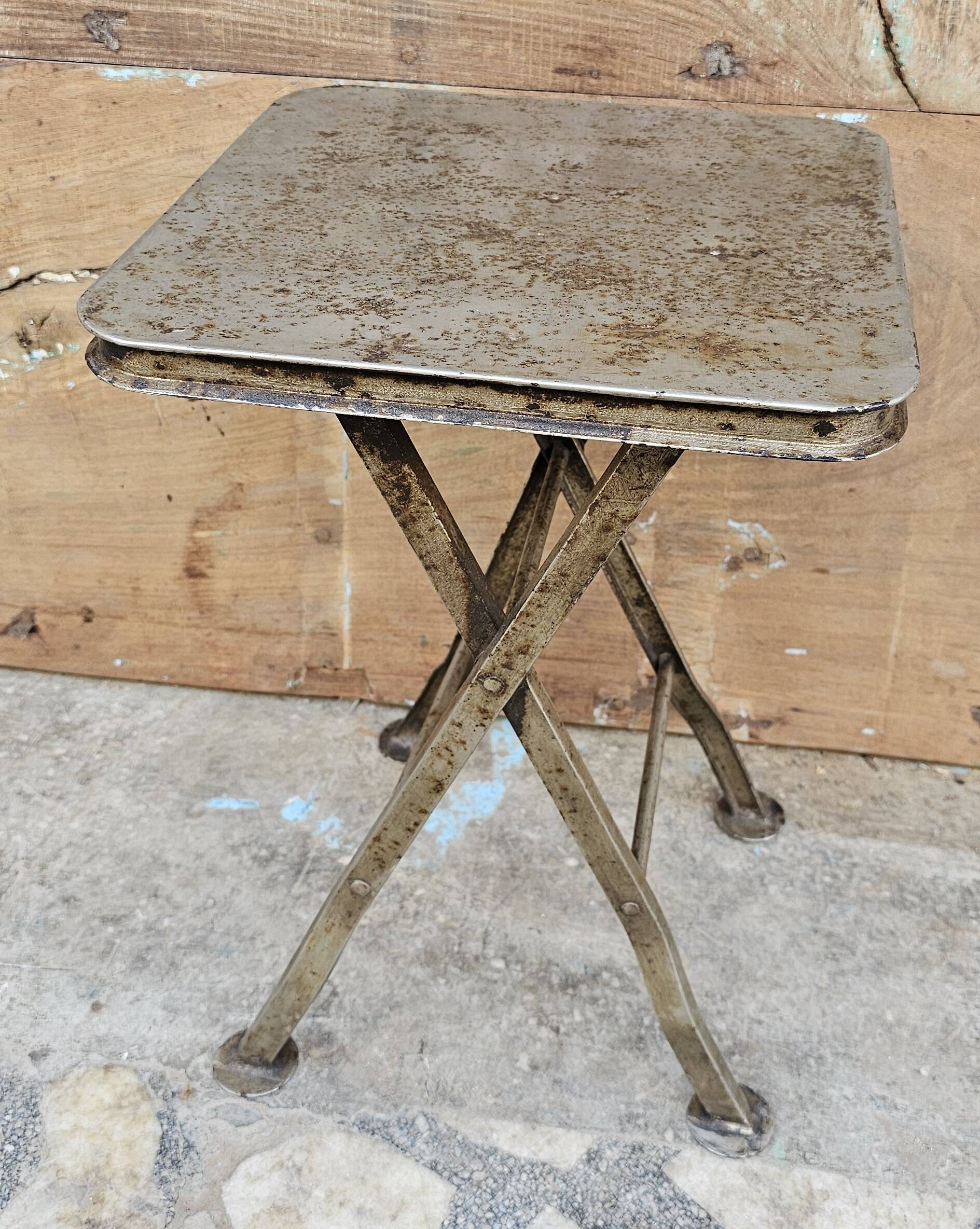 Old industrial folding steel stool