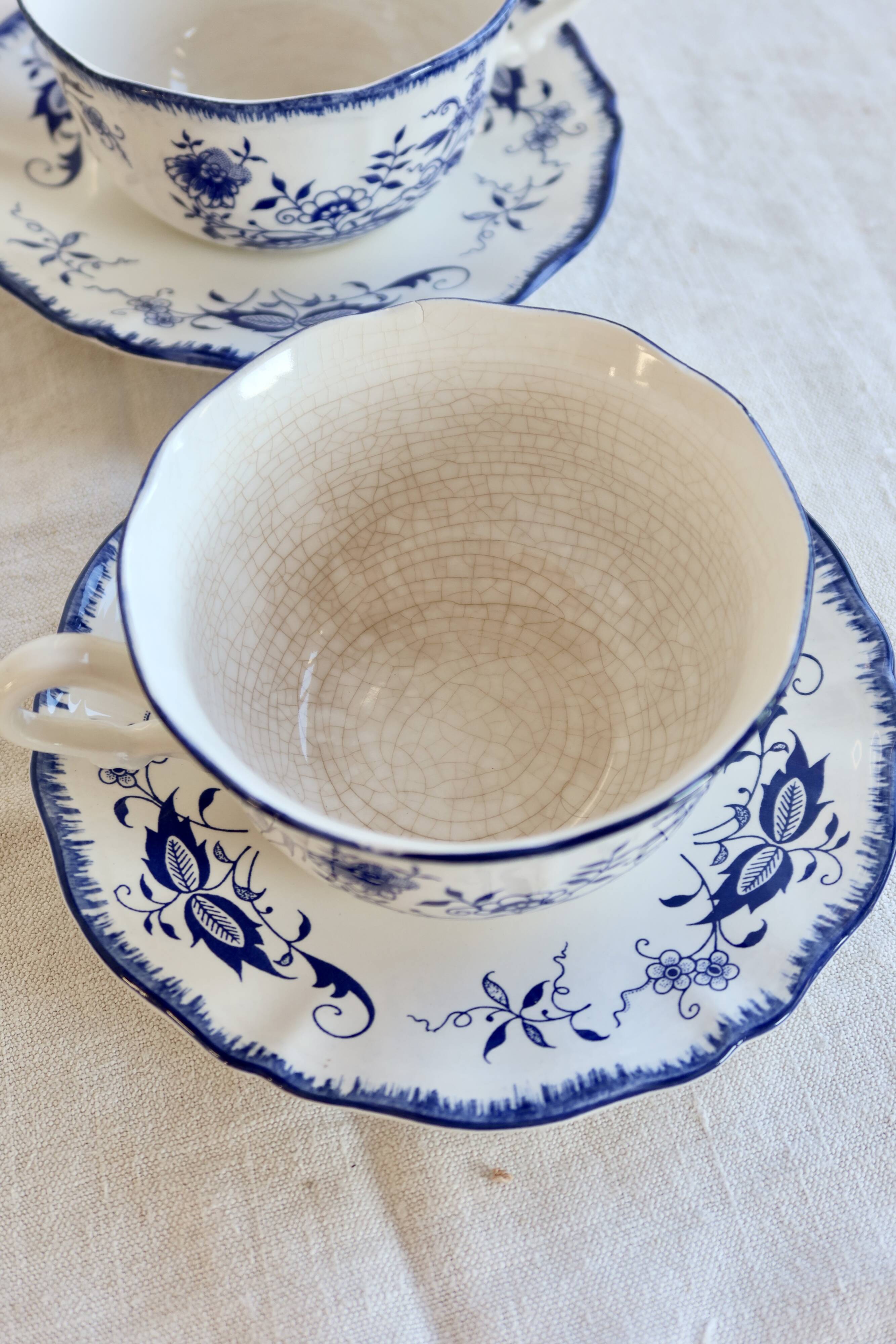 Old Lancaster cups and saucers in white earthenware with blue decoration.