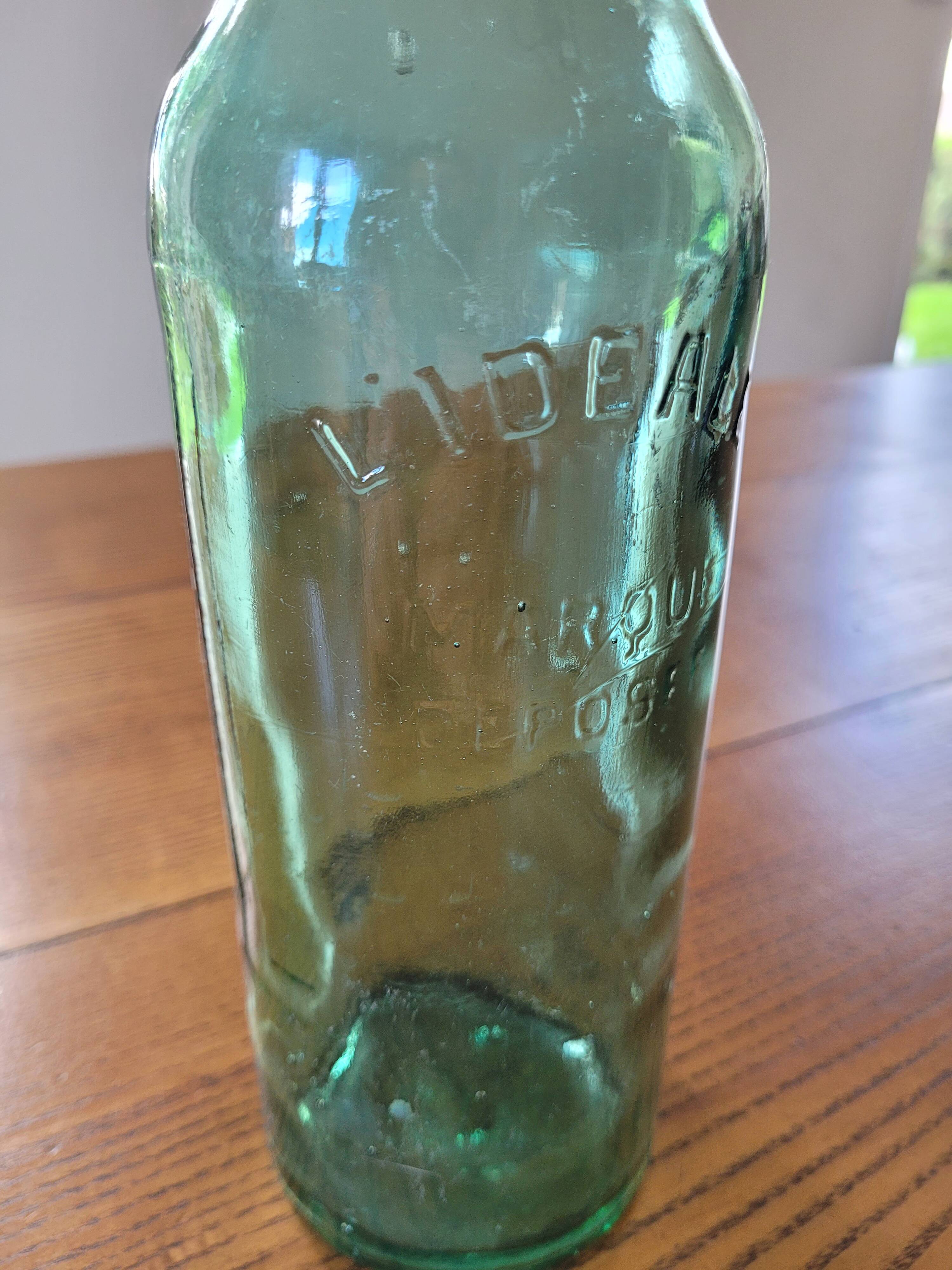Vintage glass bottle l'Idéale with porcelain stopper