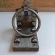 Medieval-style bookends, antique door handle.