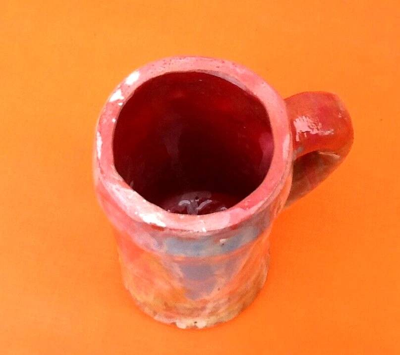 Traditional ceramic mug with a marbled glaze effect.