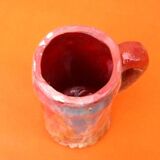 Traditional ceramic mug with a marbled glaze effect.