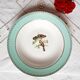 Old mismatched earthenware dinner plates accompanied by a deep dish