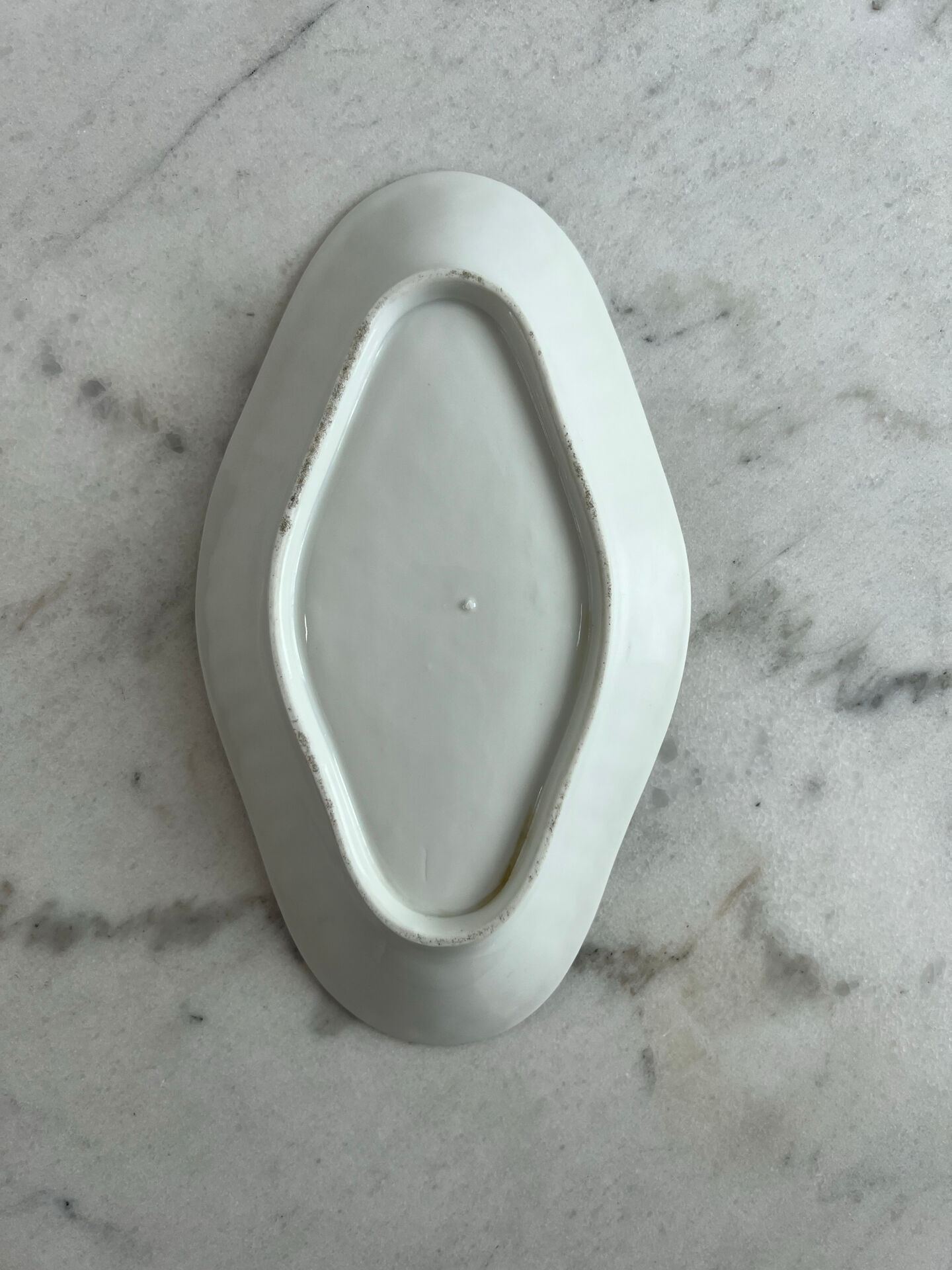 Oval white porcelain ramekin — raised floral pattern