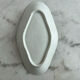 Oval white porcelain ramekin — raised floral pattern