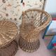 Table and two wicker chairs for children.