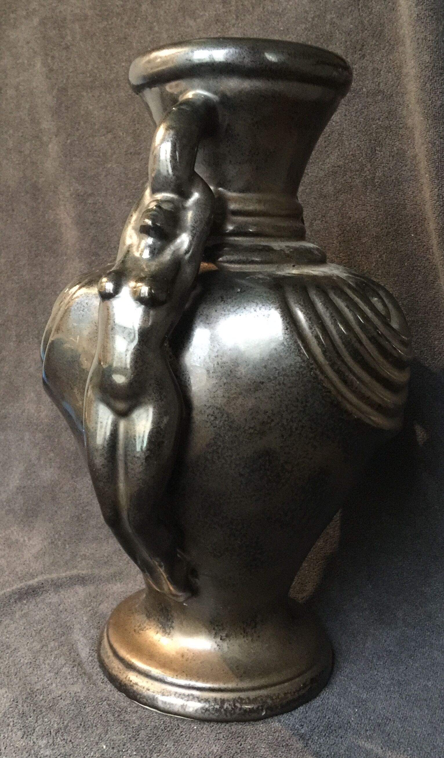 Black ceramic vase caught in naked women's bodies