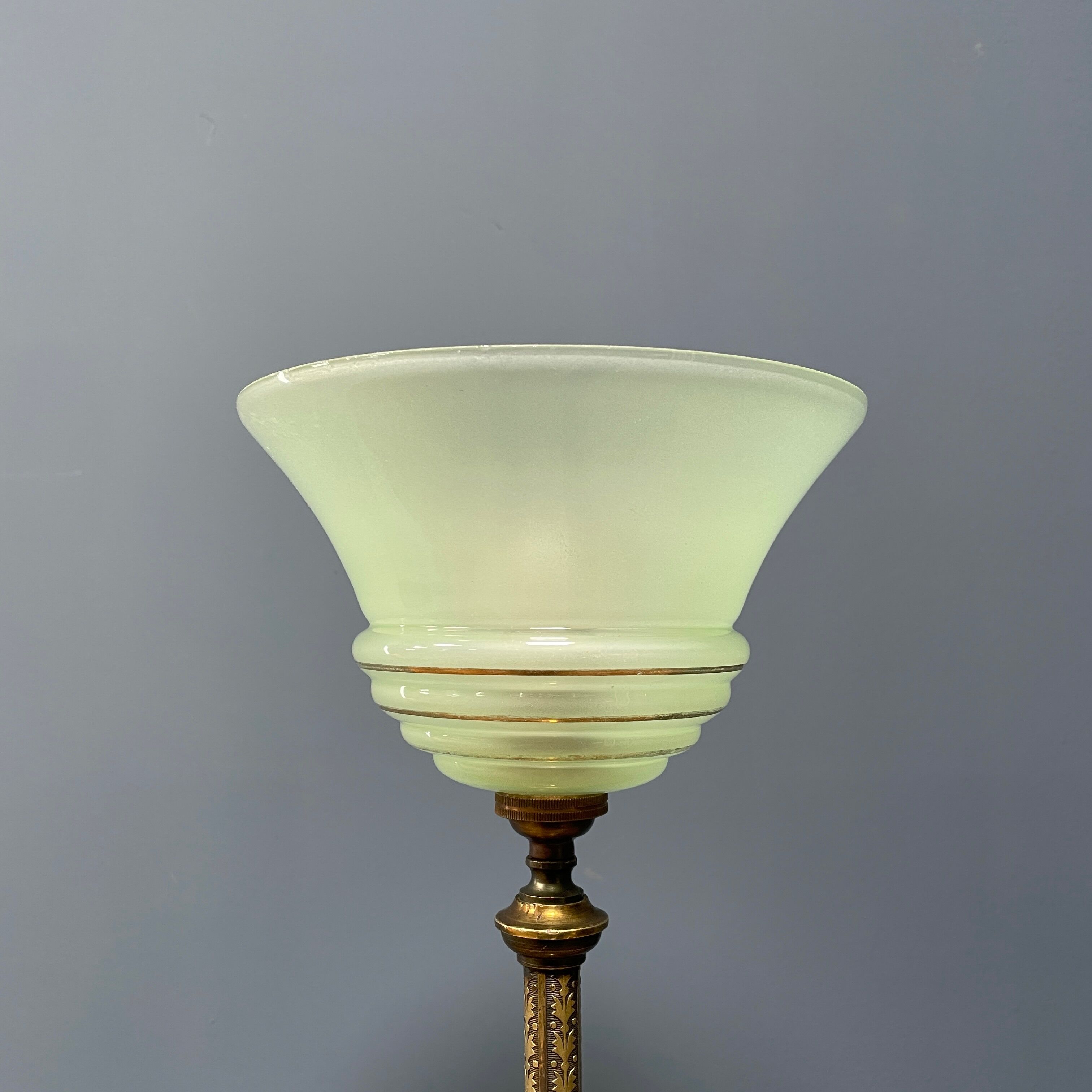 Ornate brass table lamp with mint green glass shade