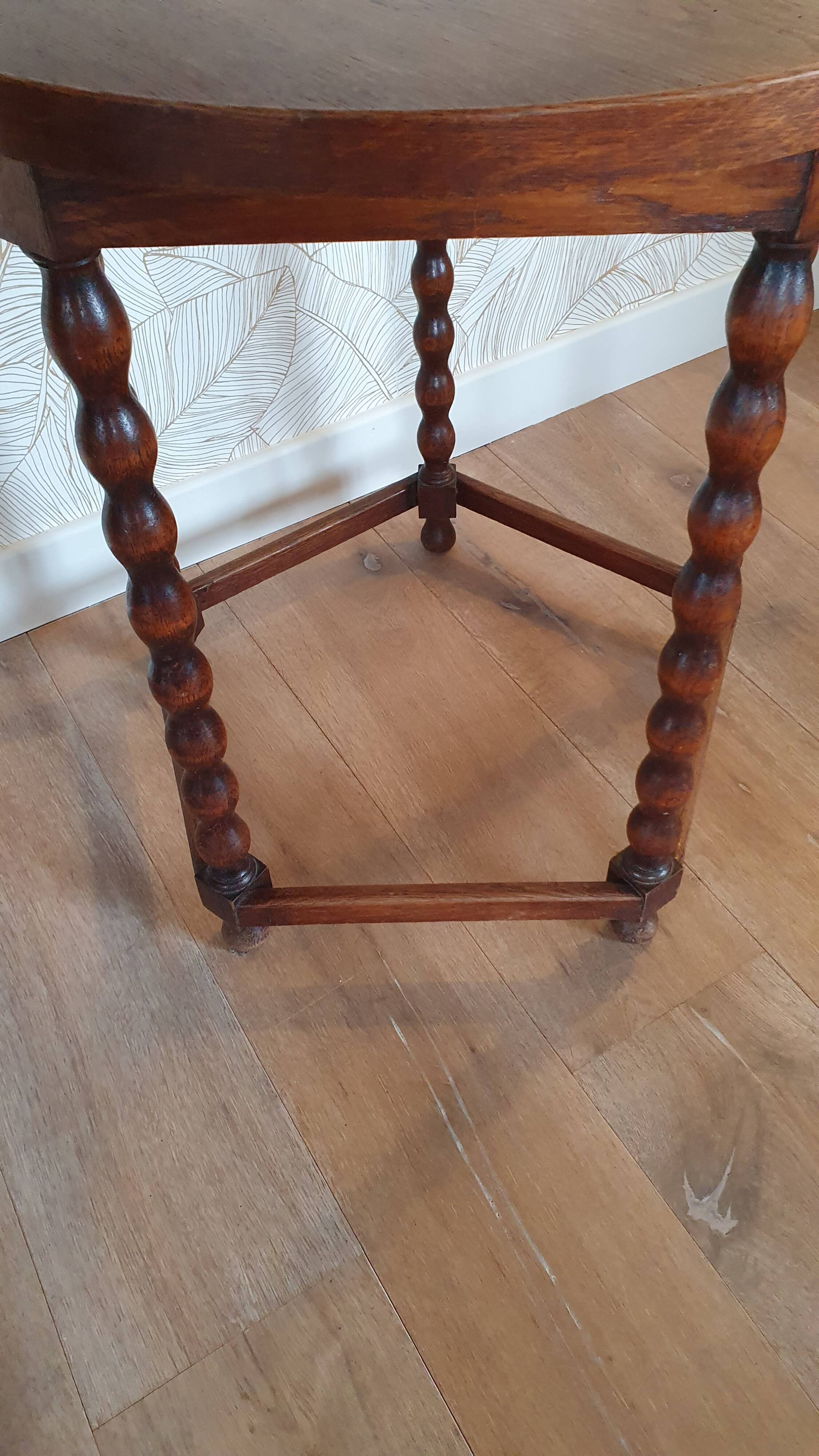 Round wooden table with beaded legs