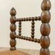 Low chair in beaded wood and straw