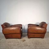 Important pair of Havana leather club armchairs, moustache models, mid-20th century.