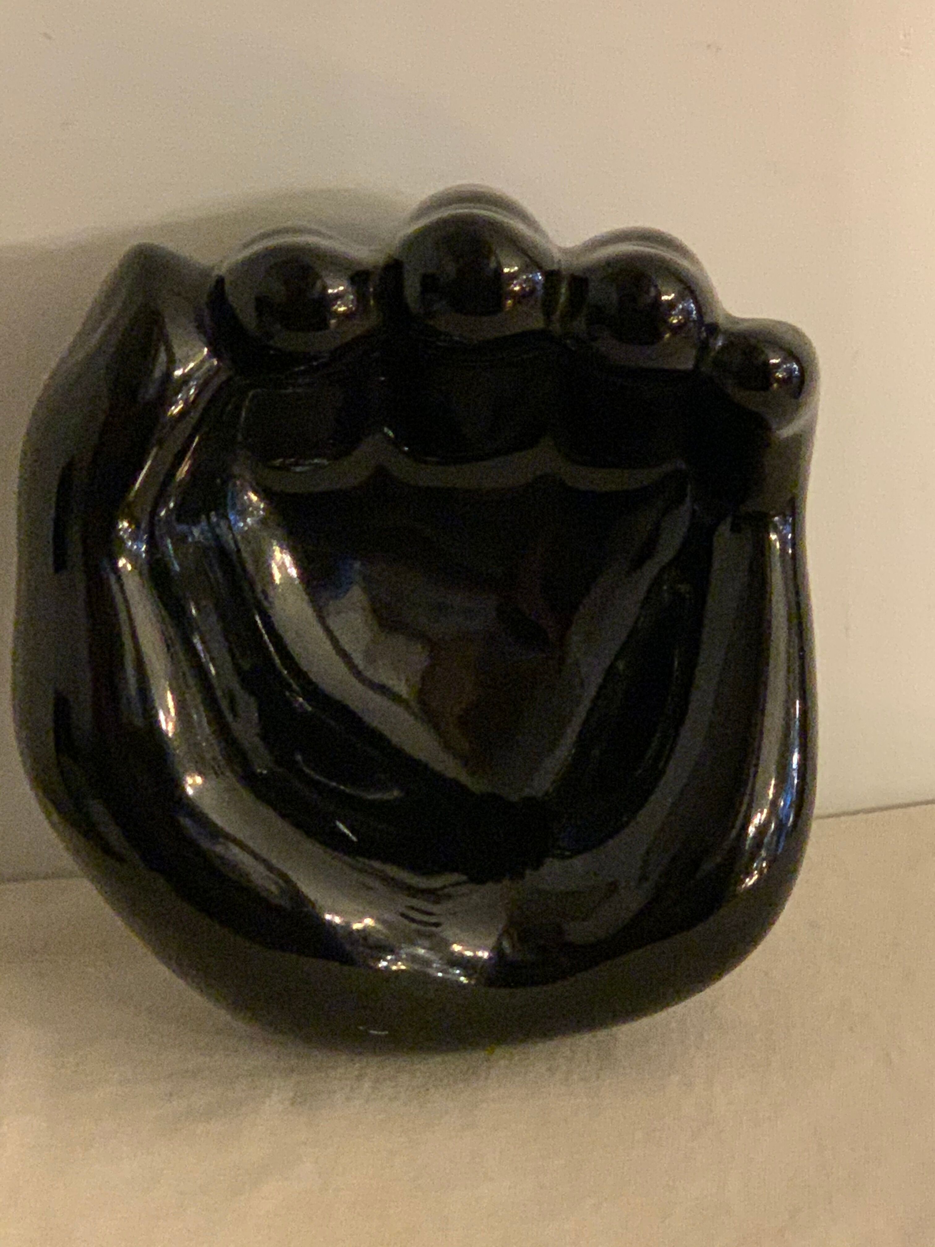 Black ceramic ashtray left hand