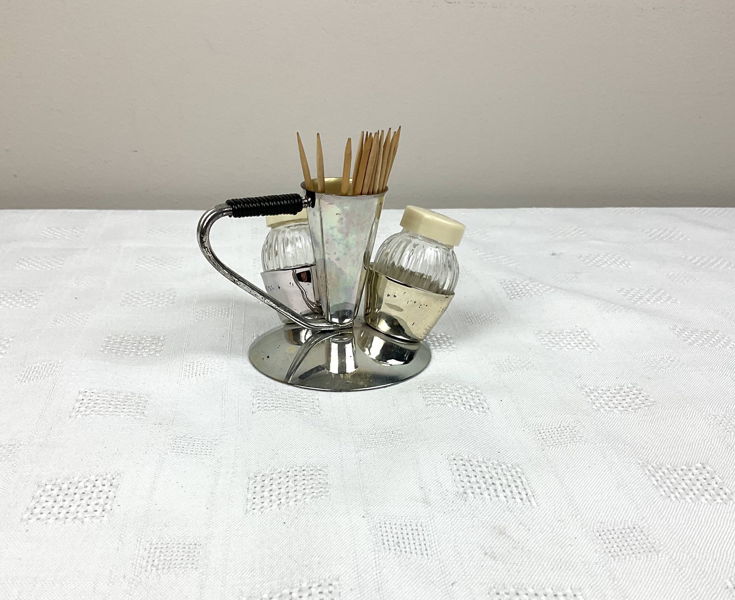Vintage salt and pepper shakers and their chrome metal support
