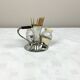 Vintage salt and pepper shakers and their chrome metal support