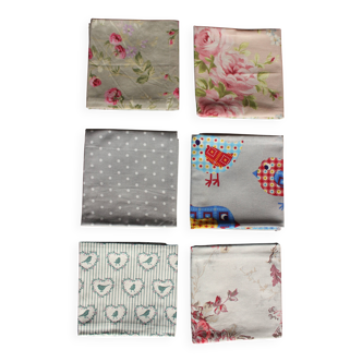 A set of 6 mismatched floral and bird-themed napkins