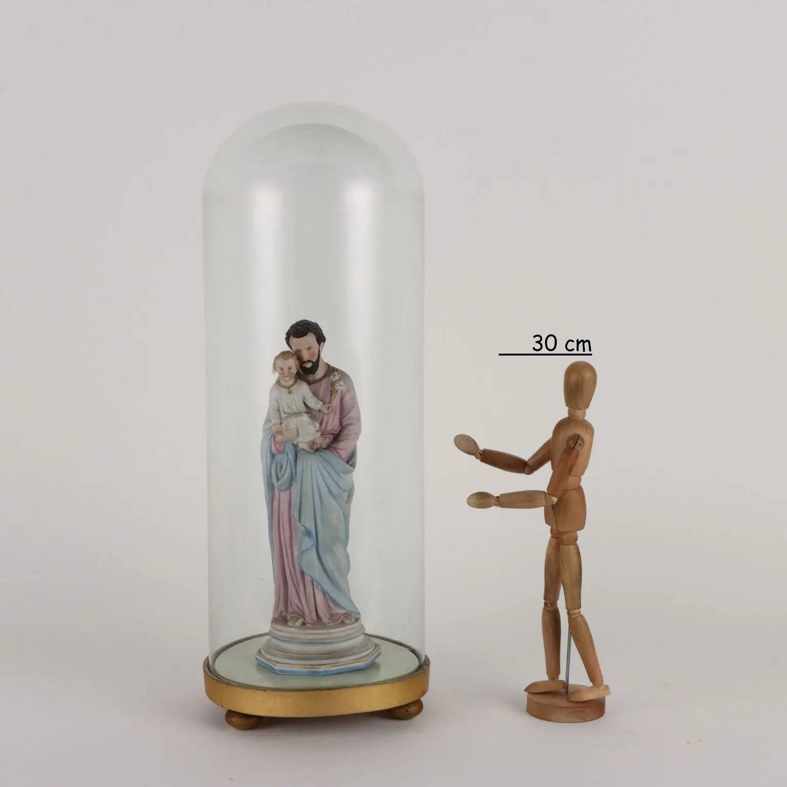 Ancient sculpture of Saint Joseph in a display case, Italy 1900s, polychrome porcelain.